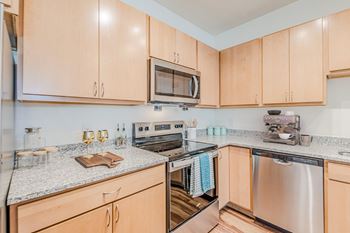 A kitchen with wooden cabinets and stainless steel appliances.